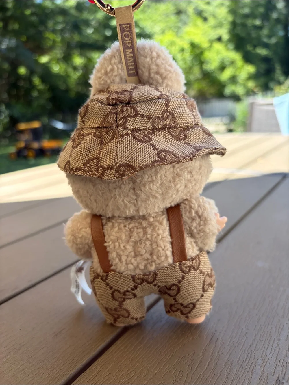 Exciting Macaroon Labubu in Toffee with designer overalls and bucket hat